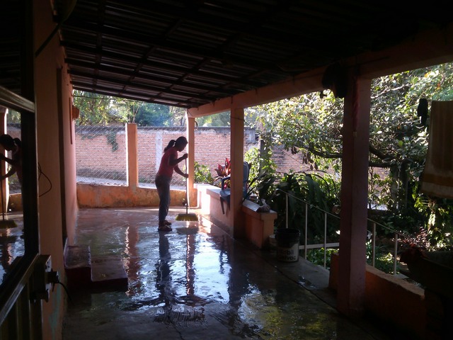 Woman washing porch, Family compound, Ocotito, Mexico